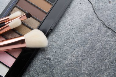 koyu arka plan üzerinde çeşitli makyaj ürünleri 