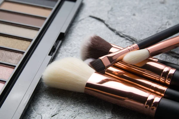Brush makeup products on dark background — Stock Photo, Image