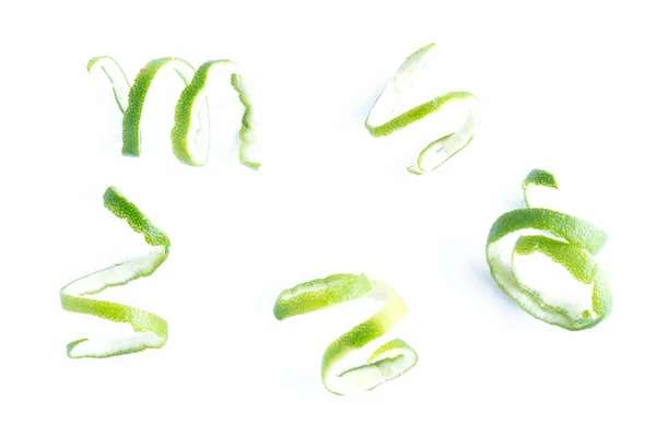 Green lemon twist on white — Stock Photo, Image