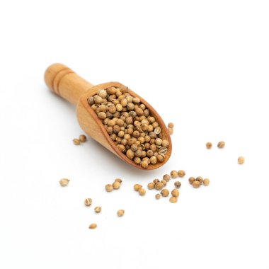 Kurutulmuş kişniş tohumları beyaz arka planda ahşap kaşık