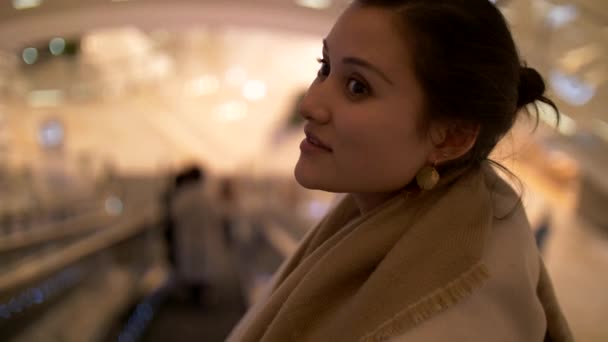 Gorgeous Young Mixed Woman on Escalator Looks Around Closeup Bokeh 4k — Stock Video