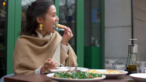 Ελκυστική νεαρή μικτή γυναίκα τρώει πίτσα και χαμογελώντας 4k — Αρχείο Βίντεο