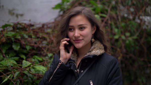 Young Mixed Woman talking on the Phone Outside with Winter Jacket on 4k — 비디오