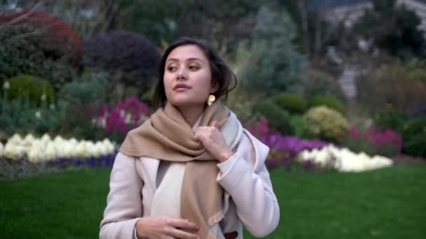 Beautiful Mixed Girl Puts Scarf on Windy Day and Adjusts Hair Bokeh 4k — 비디오