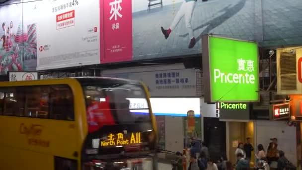Drukke straat in Hong Kong met bussen en trams bewegen snel 's nachts 4k — Stockvideo