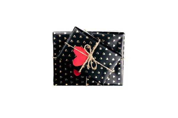 Gift boxes wrapped in black paper with hearts flat lay on white background with copy space. 8 march, Mothers day, Valentines Day gifts top view. Celebrate concept. Template for web, social media. — Stock Photo, Image