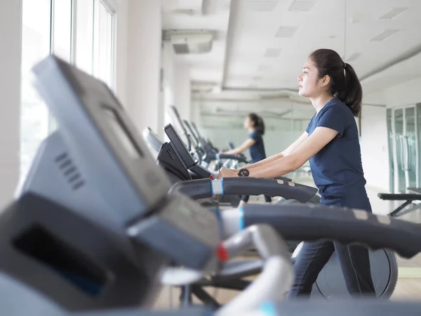 Asian woman walking,  running on treadmill gym workout. — Stock Photo, Image