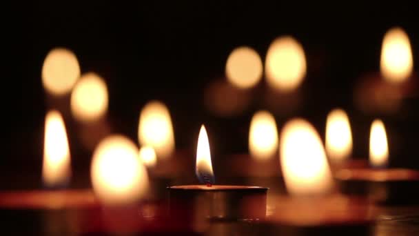 Candles light select focus, black background. — Stock Video