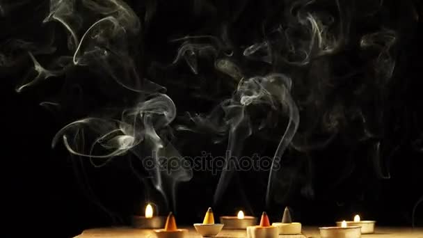 Camera tilt up, Incense cone or gum benjamin with abstract smoke, black background. — Stock Video