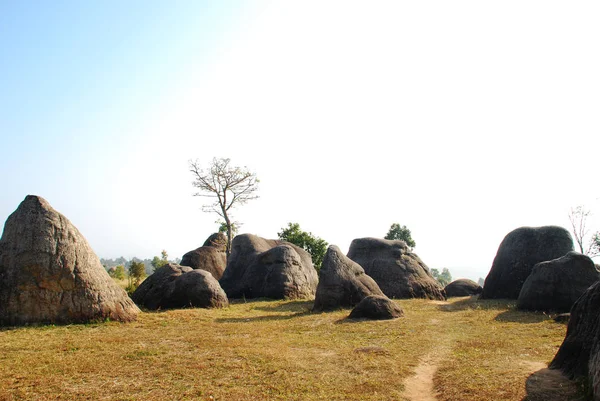 stock image The stone pile in the forest has brown grass and a clear sky. Chaiyaphum, Thailand.