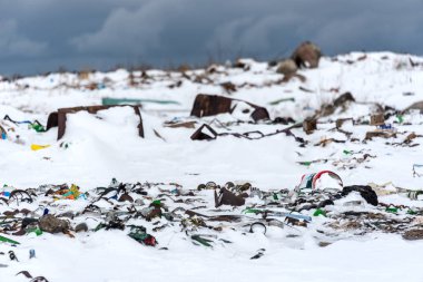 Illegal trash dump in the Arctic snow polluting the pristine environment clipart