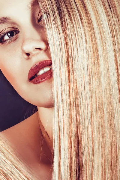 Schöne junge blonde Frau mit langen glatten Haaren auf dunklem Hintergrund — Stockfoto
