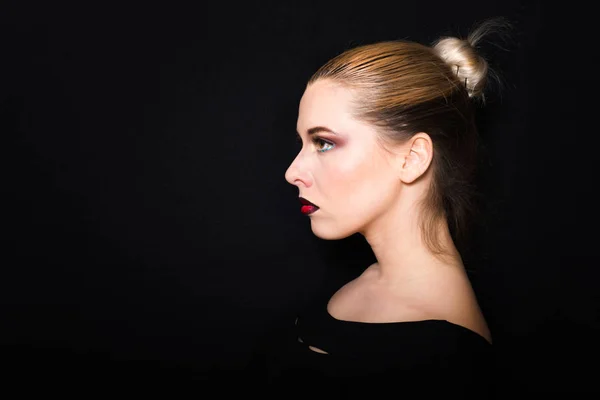 Blonde met haar verzameld in een broodje en professionele make-up met donker rode lippen — Stockfoto