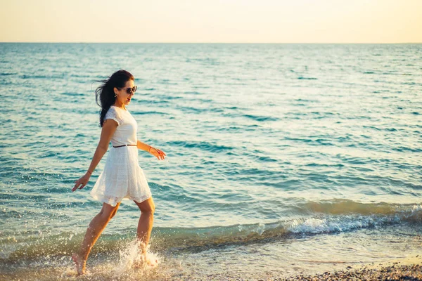 A woman runs around the sea and is happy — Stock Photo, Image