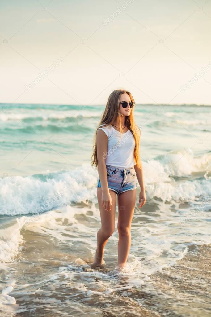 Girl on the background of the sea sunset