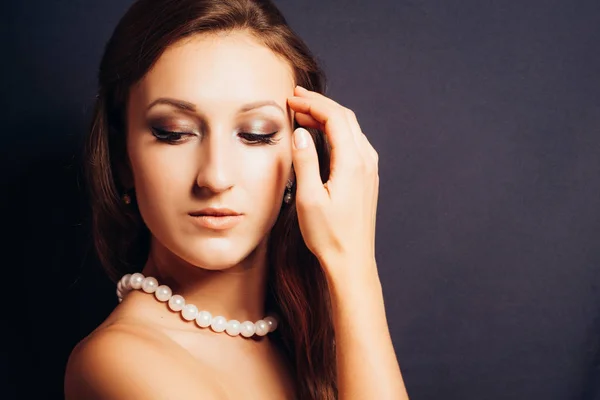 Brunette woman on a dark background close-up Royalty Free Stock Images