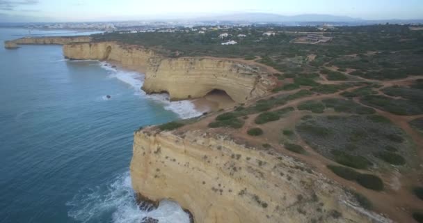 Aérea, Volando a lo largo de la empinada línea del acantilado en Ferragudo, Portugal — Vídeo de stock