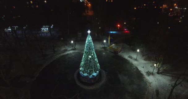 Aerial view smart Christmas tree stands on square night city — Stock Video