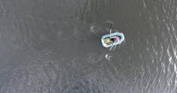 Aerial view from above of a fishermans man who row to shore in front of storm — Stock Video