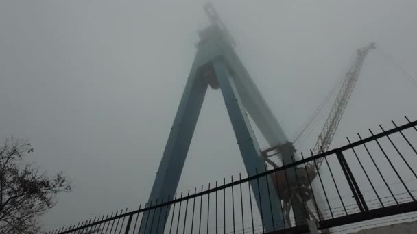 Судостроительные Краны Огромное Железо Верхушки Спрятаны Тумане Движение Вдоль Забора — стоковое видео