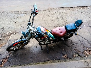 Kendi ellerinle monte edilmiş bir motosiklet su kenarında duruyor.