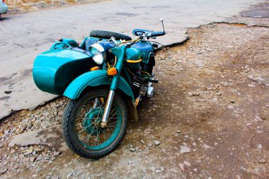 Sidecar 'ı olan eski bir Sovyet motosikleti kenarda durur. 