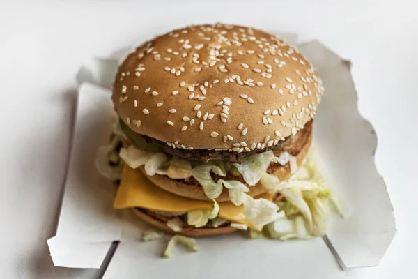 Fresh big burger on a white background. Not healthy food. Fast food concept.