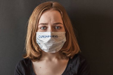 A close-up portrait of a girl in an icy mask on her face with suspected coronavirus. New Coronavirus-2019. clipart