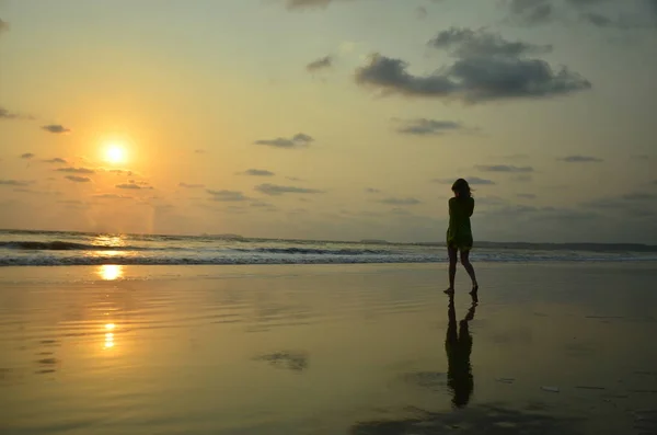 Girl walking to sunset