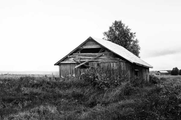 stock image The summer rain pours over the old wooden barn houses at the rural Finland.