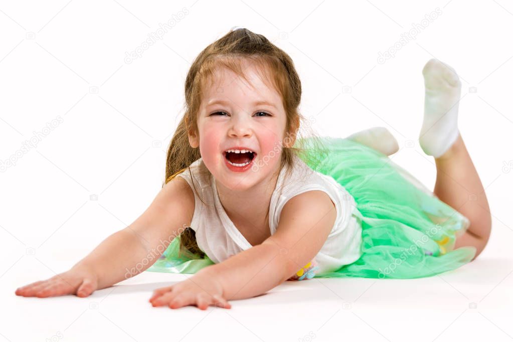 Portrait of a little cheerful girl on a white background. The child laughs