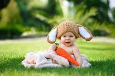 Bebek gibi bir bunny havuç oyuncak açık havada yeşil çimenlerin üzerinde ile şapkalı