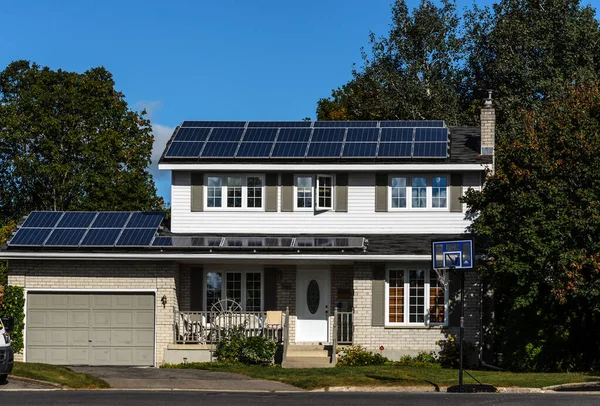 Solar panels on a suburban house rooftop