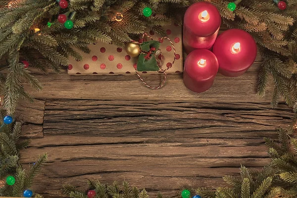 Composição de Natal Top View. Brinquedos de árvore de abeto com velas em chamas, caixas, bolas, ramos de abeto em fundo de madeira — Fotografia de Stock