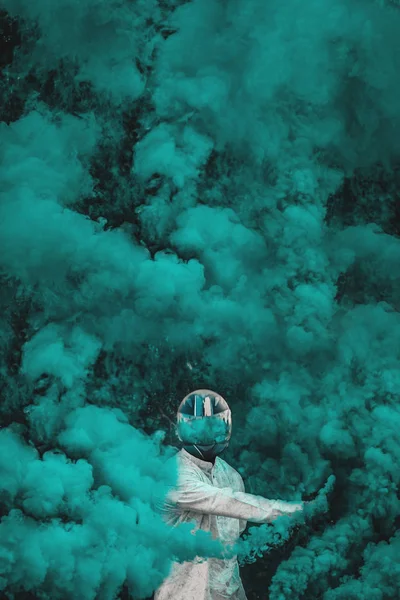 Guy in mask standing in between blue smoke bombs. vertical — Stock Photo, Image