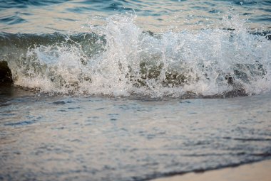 Dalgalar deniz kıyısı makrosu sıçratıyor. Yaklaş.