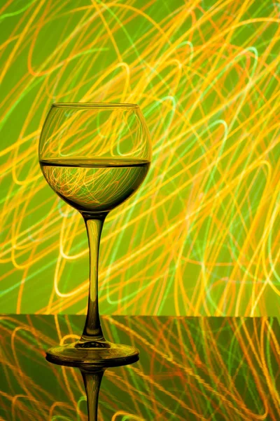 A glass of white wine on a blurred colored background — Stock Photo, Image