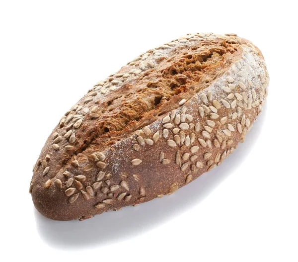 A loaf of unleavened bread with sunflower seeds close-up on a wh — Stock Photo, Image