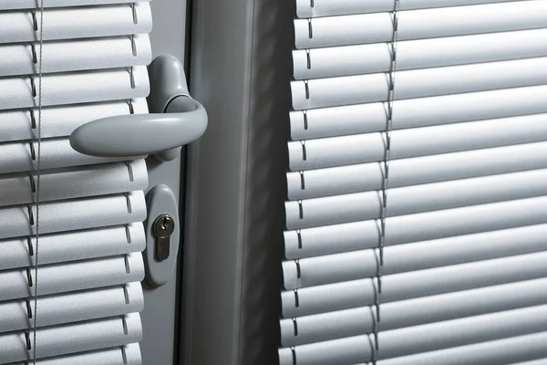 Door handle on a gray door — Stock Photo, Image