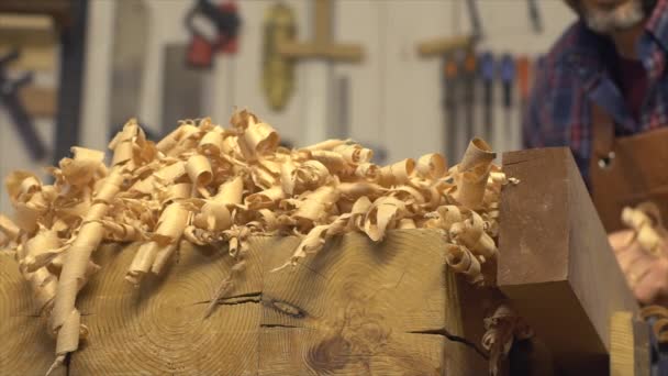 Cabinet Maker Planes Solid Wood in his Workshop — Stock Video