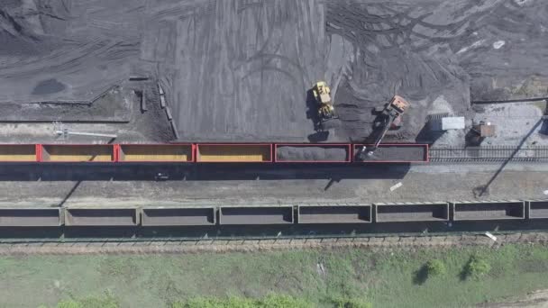 Aerial view UHD 4K of freight train with wagons and standing train with coal — Stock Video