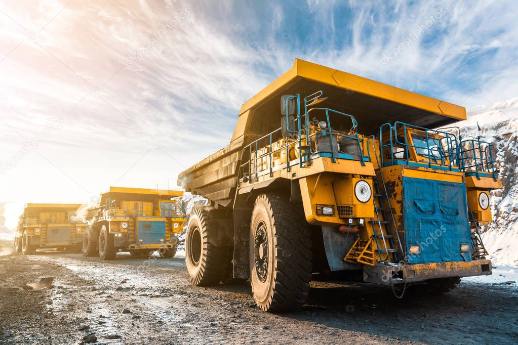 Large quarry dump truck. Loading the rock in dumper. Loading coal into body truck. Production useful minerals. Mining truck mining machinery, to transport coal from open-pit as the Coal Production.