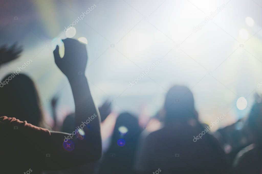 Soft focus of Christian worship with raised hand,music concert