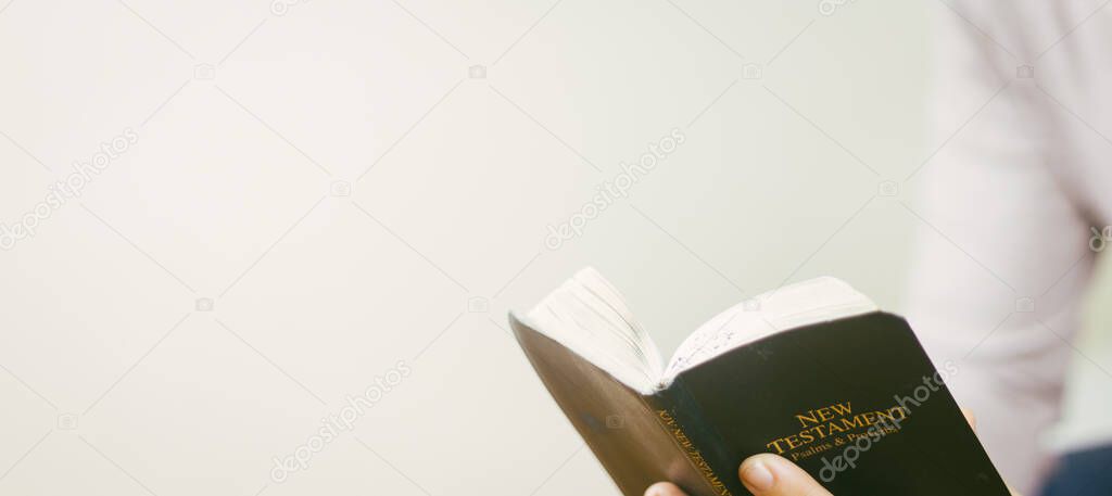 Hands woman holding open bible or devotion in God.