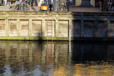 Merdiven, Kopenhag şehrinde su dolu bir kutunun duvarına asılmış. Danimarka