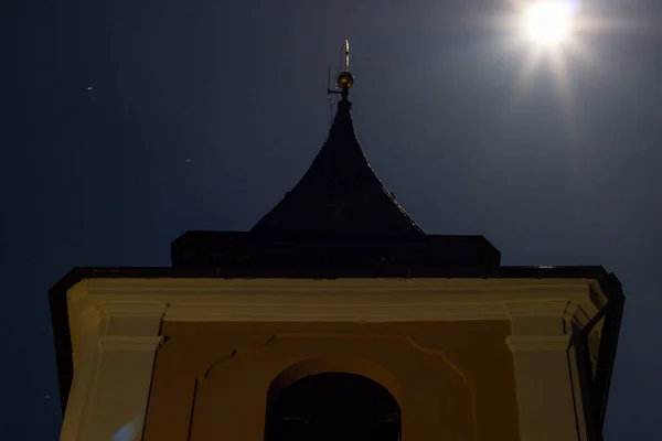 Detail of night illuminated historic Catholic church in moonlight — Stock Photo, Image