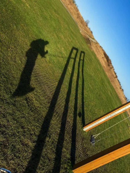 Shadow wooden swings with a guy with a beautiful panorama of the sea. Denmark — Stock Photo, Image