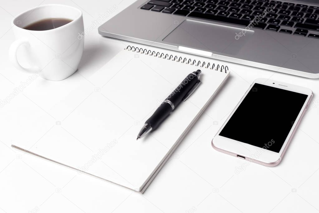 Cup With Coffee, Notebook With Pen And Smartphone Near Laptop
