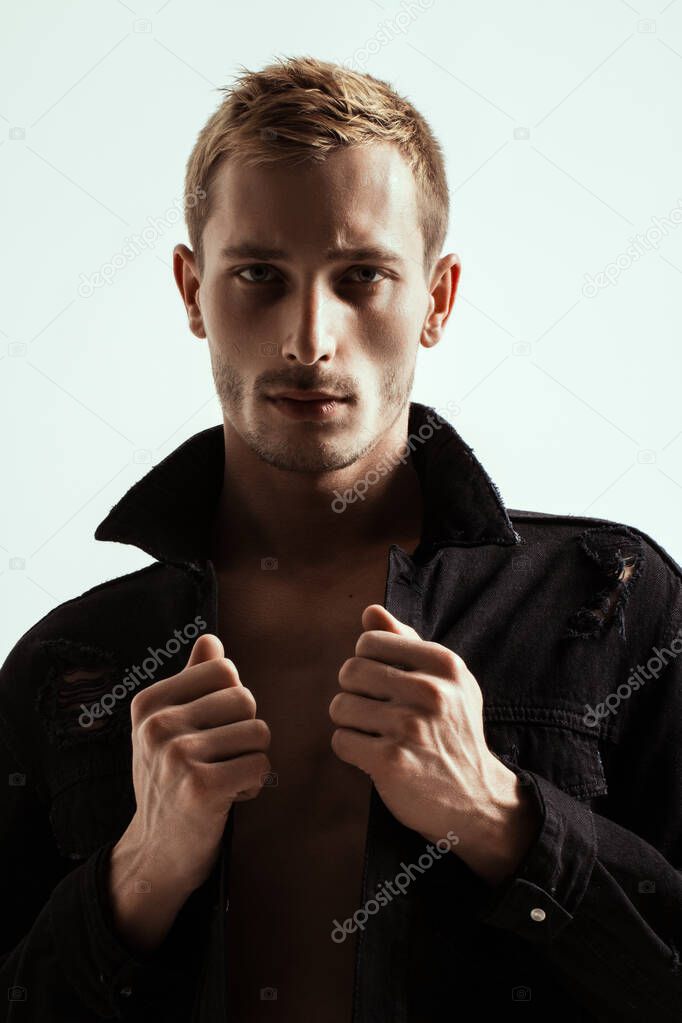 Portrait Of A Handsome Fashion Man In Black Jean Jacket On White Background