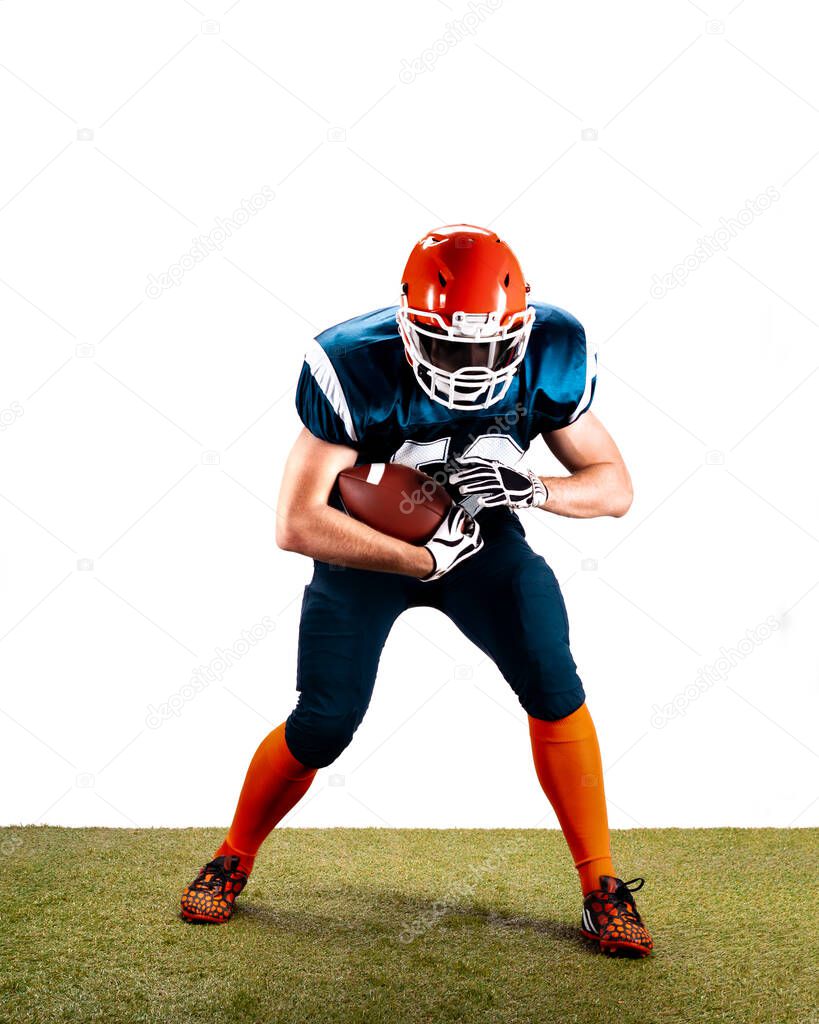 American football player with ball in action on the grass isolated on the white